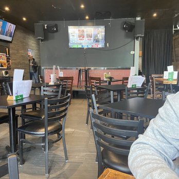 Le Poutine Bar - a man sitting at a table - Poutineries Near Me - Laval, Quebec Le Poutine Bar - a man sitting at a table - Poutineries Near Me - Laval, Quebec
