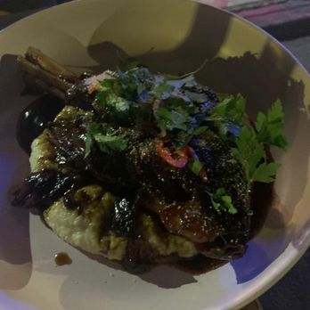 Otis - Lamb Shank Roasted Garlic Grits/Herb Salad/Pickled Chili - New American Near Me - Brooklyn, New York Otis - Lamb Shank Roasted Garlic Grits/Herb Salad/Pickled Chili - New American Near Me - Brooklyn, New York