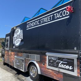 a taco truck parked in a parking lot a taco truck parked in a parking lot