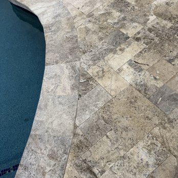 Benchmark Landscape & Design - Showing discoloration of travertine already, which was just installed in March. - Landscaping Near Me