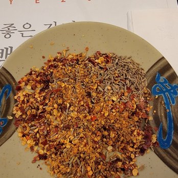 Ming Xing BBQ - Cumin dry seasoning that's on the house. Just add red pepper flakes and cumin seeds to your liking. - Barbeque Near Me - Flushing, New York