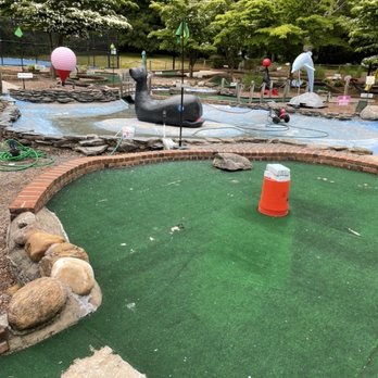 Whale's Tale - This is the 18th hole. Literally a Home Depot bucket with bricks on top. Note the "water feature" and greens. - Mini Golf Near Me - Shelter Island, New York Whale's Tale - This is the 18th hole. Literally a Home Depot bucket with bricks on top. Note the "water feature" and greens. - Mini Golf Near Me - Shelter Island, New York