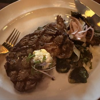 The Mercantile Chophouse - 14 oz. Ribeye with Gorgonzola Bacon Butter and Brussel Sprouts - Steakhouses Near Me - King, North Carolina The Mercantile Chophouse - 14 oz. Ribeye with Gorgonzola Bacon Butter and Brussel Sprouts - Steakhouses Near Me - King, North Carolina