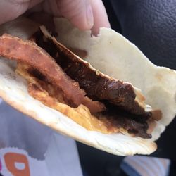 Dunkin' - Beyond burnt breakfast wrap. The black stuff is cheese.. didn't dissect it enough to see if they even put the egg in there.