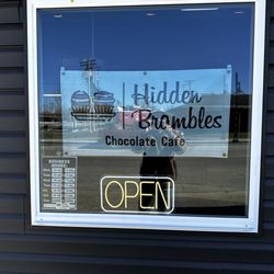 Hidden Brambles - Front window sign and hours.