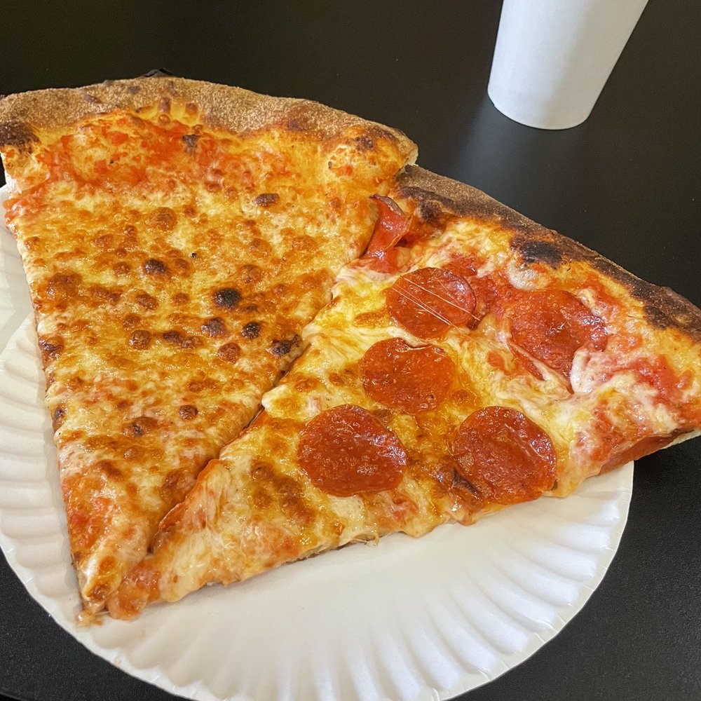 two slices of pizza on a paper plate two slices of pizza on a paper plate