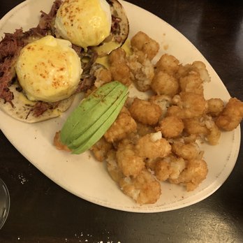 Syrup Downtown - Eggs Benedict with avocado & smash taters with a glass of pineapple mimosa. - Breakfast & Brunch Near Me - Denver, Colorado