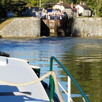 Saroche Charter Barge - Barge  in canal approaching lock, Burgundy region, France - Boat Charters Near Me