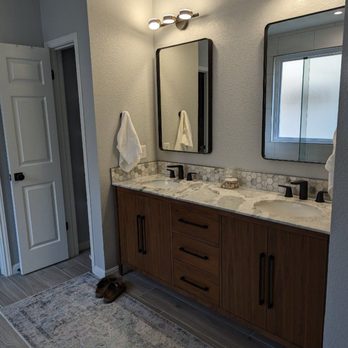 Martin Construction - a bathroom with double sinks and mirrors - General Contractors Near Me