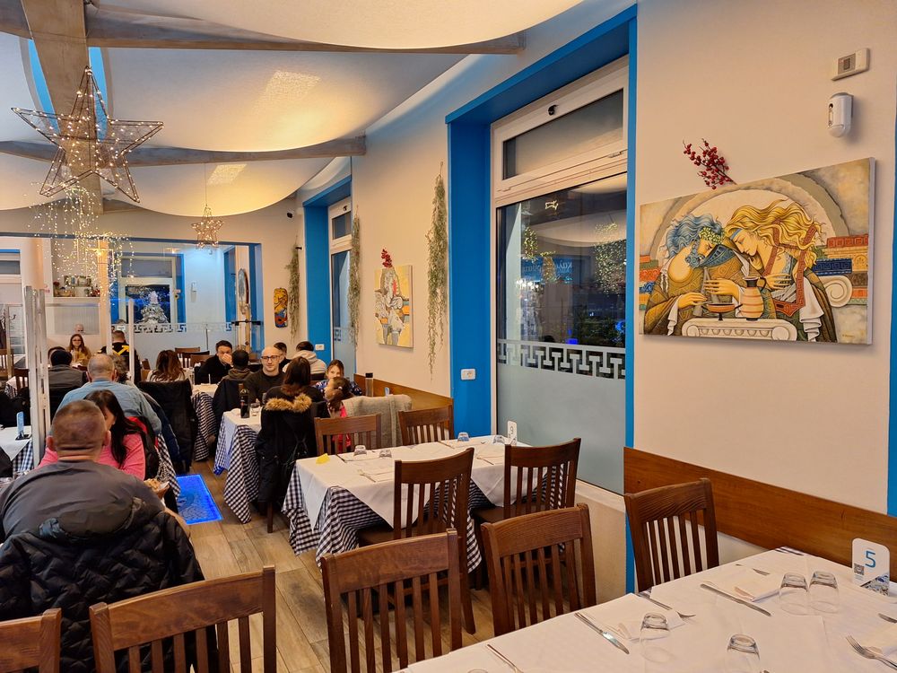 Taverna Greca - Winter visit: looking from the rear of the restaurant toward the front door - interior - Greek Near Me - Torino, TO Taverna Greca - Winter visit: looking from the rear of the restaurant toward the front door - interior - Greek Near Me - Torino, TO