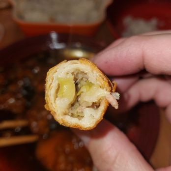 Fortune Wok - a person holding a piece of food - Chinese Near Me - Overland Park, Kansas