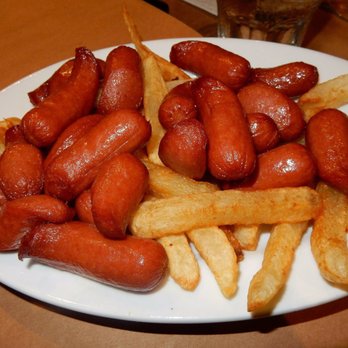 Pio Pio 2 - Close up of fried hot dogs and fries. Drown these in green sauce! - Latin American Near Me - Jackson Heights, New York