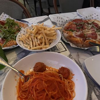 Barbusa - Spaghetti with meatballs, Garlic Parmesan fries, and two of their pizzas. Left pizza is Prosciutto E Tartufo Right pizza is Dolci E Picante - Italian Near Me - San Diego, California Barbusa - Spaghetti with meatballs, Garlic Parmesan fries, and two of their pizzas. Left pizza is Prosciutto E Tartufo Right pizza is Dolci E Picante - Italian Near Me - San Diego, California