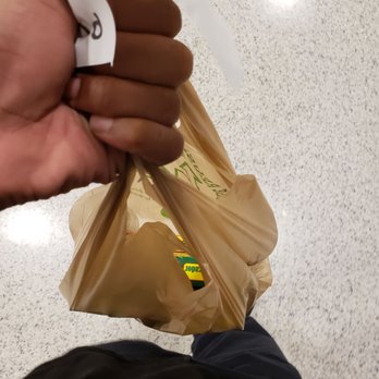 Publix - a person holding a bag of food - Grocery Near Me - Miami Shores, Florida