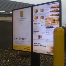 a menu on a sign in front of a building a menu on a sign in front of a building