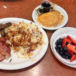 Wade's Cafe - Hash browns,ham,bacon,and Sausage with pancakes and fruit. Not an egg eater.