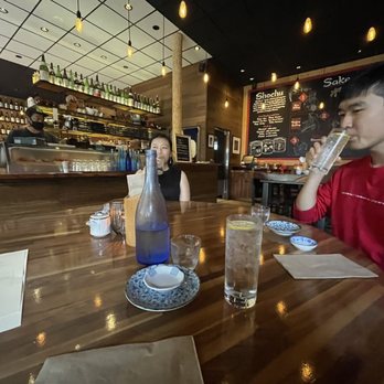 Tsunami Panhandle - a man and a woman sitting at a table - Sushi Bars Near Me - San Francisco, California Tsunami Panhandle - a man and a woman sitting at a table - Sushi Bars Near Me - San Francisco, California