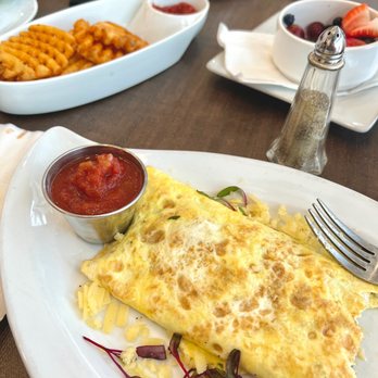 Anonymous Cafe - Four egg omelet, fresh cut fries and the fresh seasonal fruit In the background. - Coffee & Tea Near Me - Houston, Texas Anonymous Cafe - Four egg omelet, fresh cut fries and the fresh seasonal fruit In the background. - Coffee & Tea Near Me - Houston, Texas