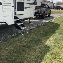Cross Roads RV - Gravel lot with grass in the front.