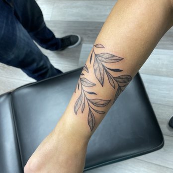 Titan Tattoo - Wrap around vine tattoo - Piercing Near Me - Nashville, Tennessee Titan Tattoo - Wrap around vine tattoo - Piercing Near Me - Nashville, Tennessee