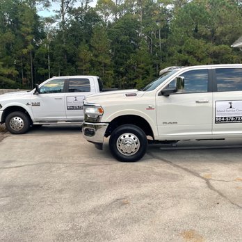 Island Service Group - two trucks parked in front of a house - Landscaping Near Me - Fernandina Beach, Florida Island Service Group - two trucks parked in front of a house - Landscaping Near Me - Fernandina Beach, Florida