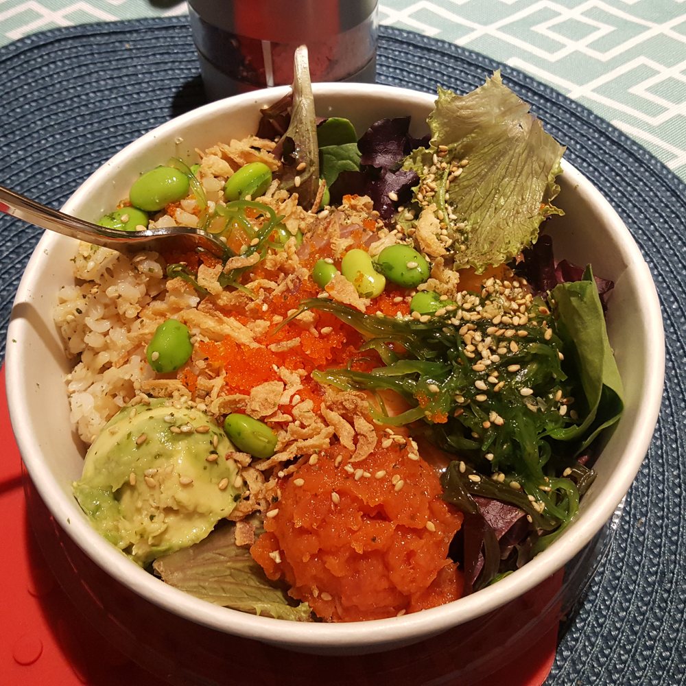 Wicked Poke - Digging into a half&half greens and brown rice bowl with avocado, spicy tuna, salmon, albacore, masago, seaweed, fried onion, and sesame - Poke Near Me - Oceanside, California