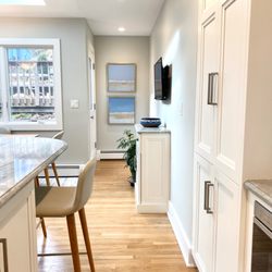 Lauren Heller Art Consultant - This project included the installation of two original paintings with a coastal color scheme in the client's kitchen.