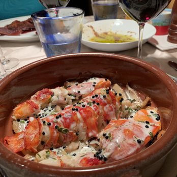 Cote D'Azur - Dinner table...lobster, Cote du Rhône wine, olive oil with fresh bread, crispy duck in the background. - French Near Me - Naples, Florida Cote D'Azur - Dinner table...lobster, Cote du Rhône wine, olive oil with fresh bread, crispy duck in the background. - French Near Me - Naples, Florida