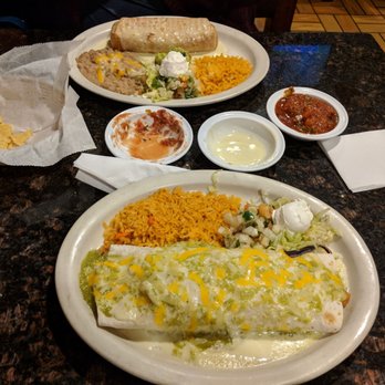 Mariachis II Mexican Restaurant - Burrito at the forefront and chimichanga in the background with salsa and cheese in the middle. Really great meal. - Mexican Near Me - St Louis, Missouri Mariachis II Mexican Restaurant - Burrito at the forefront and chimichanga in the background with salsa and cheese in the middle. Really great meal. - Mexican Near Me - St Louis, Missouri