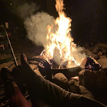 Whispering Pines Campground - Our legs, relaxing on our double rocking seat by our fire! Living life and so peaceful and content! - Campgrounds Near Me - Hope Valley, Rhode Island Whispering Pines Campground - Our legs, relaxing on our double rocking seat by our fire! Living life and so peaceful and content! - Campgrounds Near Me - Hope Valley, Rhode Island