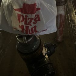 Pizza Hut - My wings are in a brown and plastic bag because it's rainy and I have my ranch and umbrella my eat one now.