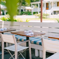 Sullivan’s Fish Camp - Our front seating area includes a large umbrella designed to keep you comfortably shaded and cool.