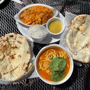 Sherpa's Adventures Restaurant & Bar - Thukpa noodles at the bottom, korma on the top, garlic naan on the left, regular naan on the right - Himalayan/Nepalese Near Me - Boulder, Colorado