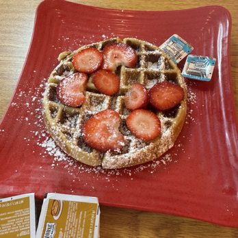 Red Balloon Cafe - Big Beautiful Waffle topped with syrup, powdered sugar and delicious strawberry slices, so good! - Comfort Food Near Me - Houston, Texas Red Balloon Cafe - Big Beautiful Waffle topped with syrup, powdered sugar and delicious strawberry slices, so good! - Comfort Food Near Me - Houston, Texas