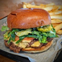 Deep Cuts - Smash Patty - Quarter lb patty, american cheese, shrettuce, tomato, onion, 1,000 island, griddled brioche bun.