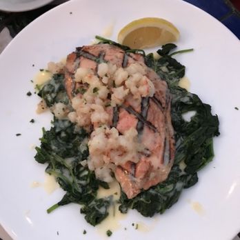 Vivace - Salmon with rock shrimp over sautéed spinach with lemon butter sauce - Italian Near Me - Tucson, Arizona Vivace - Salmon with rock shrimp over sautéed spinach with lemon butter sauce - Italian Near Me - Tucson, Arizona