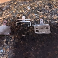 Disintegrated brake pad on right