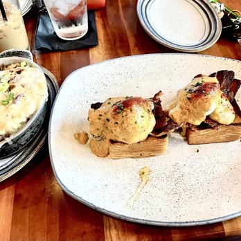 The Butter Milk Ranch - Eggs benny (bacon and corn gravy) with loaded potatoes - Breakfast & Brunch Near Me - Nashville, Tennessee