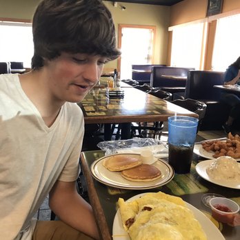Alli's Family Restaurant - German omelet bigger than his head. - New American Near Me - Springfield, Missouri