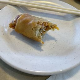 Partially eaten spring roll. Partially eaten spring roll.