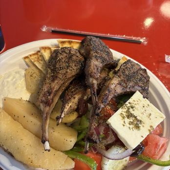 The Greeks - Perfect large juicy lamb chops, potato wedges, tomato, green peppers, olives, pita bread and feta cheese. - Greek Near Me - Wilmington, North Carolina The Greeks - Perfect large juicy lamb chops, potato wedges, tomato, green peppers, olives, pita bread and feta cheese. - Greek Near Me - Wilmington, North Carolina