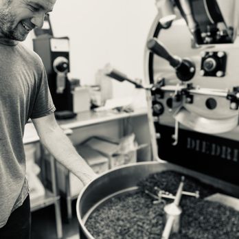 Dark Water Coffee Roasters - a man roasting coffee beans - Coffee Roasteries Near Me - Hart, Michigan
