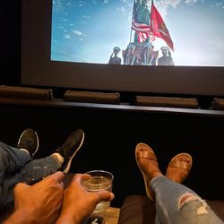 Malco Renaissance Cinema Grill - Glass of wine in hand and seating in clean, comfy recliners