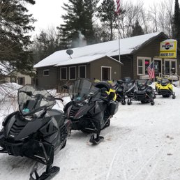 a row of snowmobiles parked in front of a building