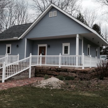 Petti Construction - a blue house with white railings - General Contractors Near Me - Wadsworth, Ohio