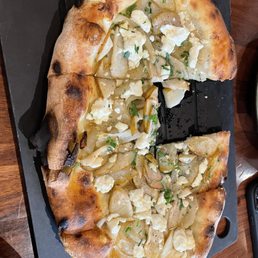 Pear and caramelized onion pizza with hot honey drizzle