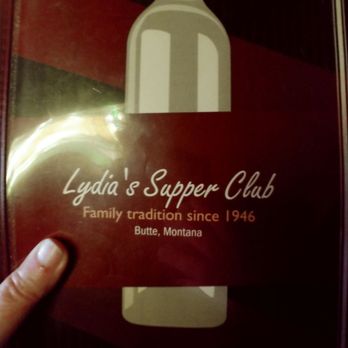 Lydia's Supper Club - a hand holding a bottle of wine - Italian Near Me - Butte, Montana Lydia's Supper Club - a hand holding a bottle of wine - Italian Near Me - Butte, Montana