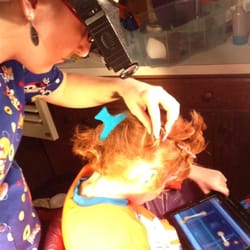 LiceDoctors - Mid Hudson Valley - LiceDoctors technician checks for lice and nits (eggs) in her client's hair.