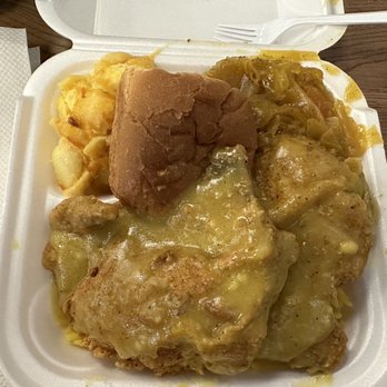 Seana's - Smothered pork chops over yellow rice, cabbage, and liquid gold max and cheese - Caribbean Near Me - Orlando, Florida Seana's - Smothered pork chops over yellow rice, cabbage, and liquid gold max and cheese - Caribbean Near Me - Orlando, Florida