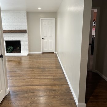 Mayen Builders - Removed tile in the entry way & able to salvage the hardwood underneath the tiling to have consistent flooring as living room & hallway. - General Contractors Near Me